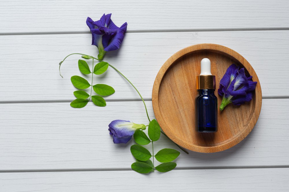 serum-bottle-butterfly-pea-flower-oil-put-wooden-tray