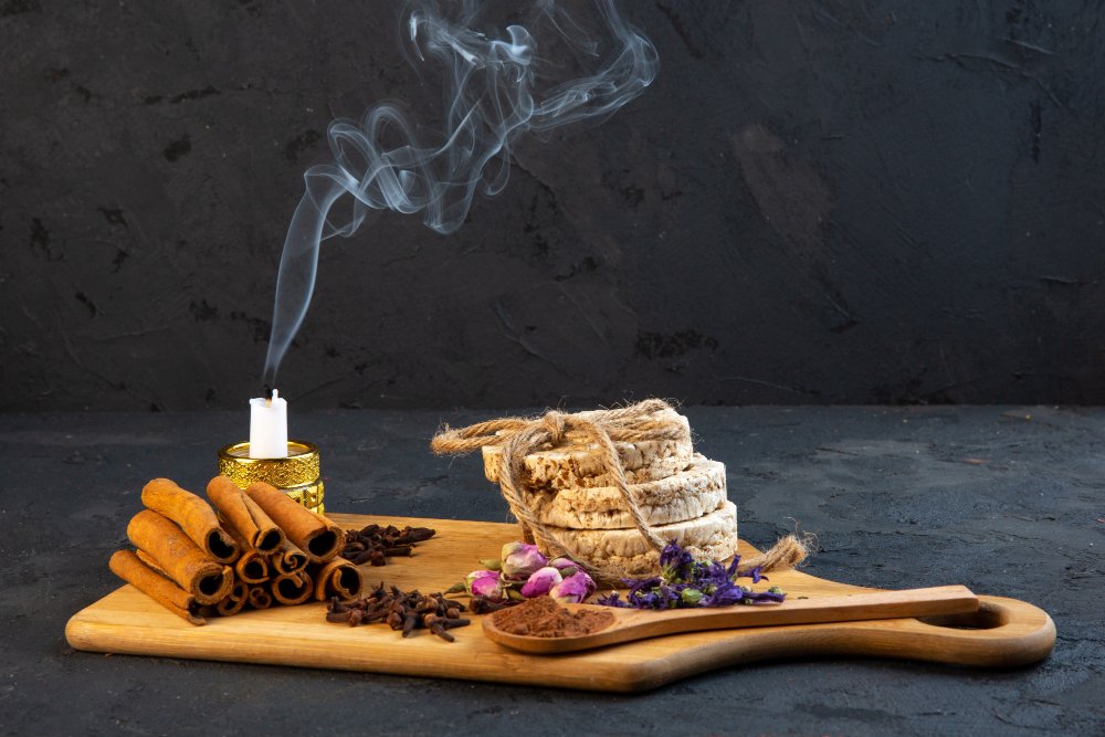 side-view-cinnamon-with-stewed-candle-dried-flowers